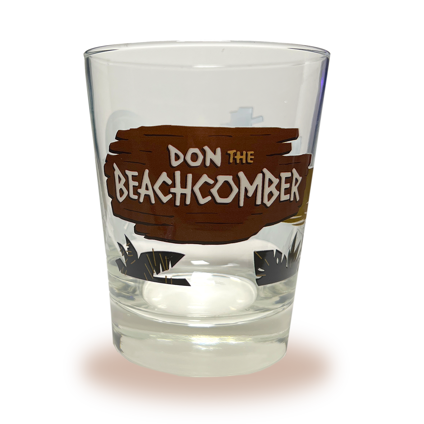 A Mai Tai glass with Donn Beach leaning on a rum barrel on a beach that says “rum ship to Donn Beach” on one side and the Don the Beachcomber Logo on the other side.
