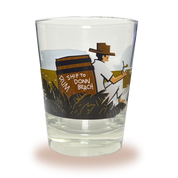 A Mai Tai glass with Donn Beach leaning on a rum barrel on a beach that says “rum ship to Donn Beach” on one side and the Don the Beachcomber Logo on the other side.